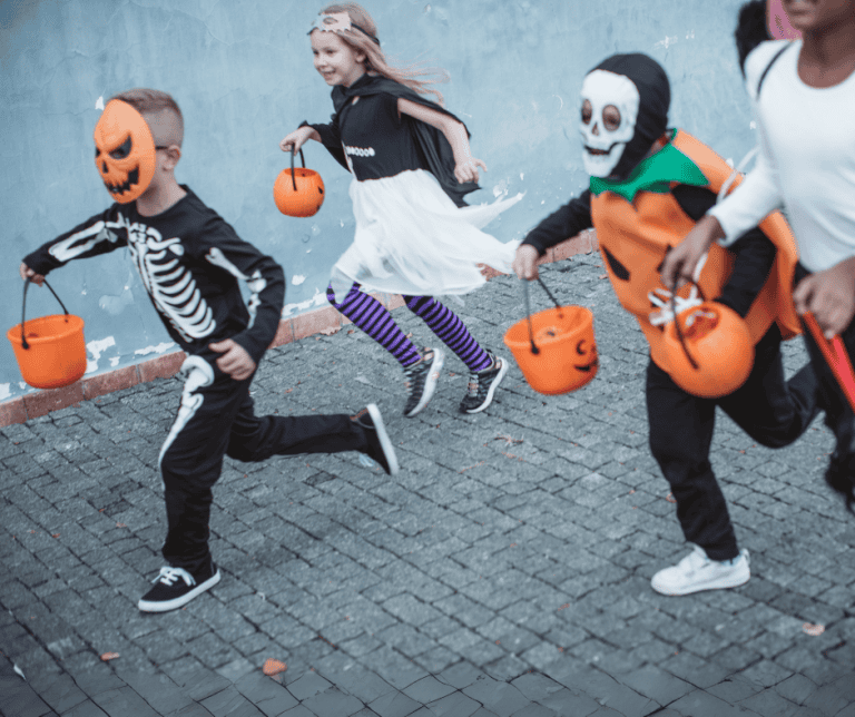 kids in Halloween costumes running