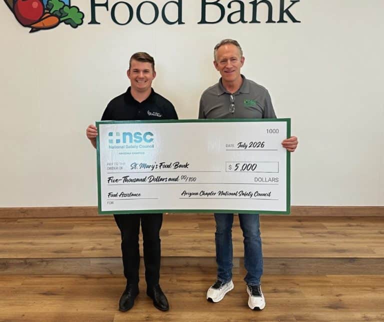 John Drake and Rick Murray holding big donation check